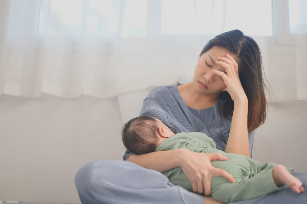 Baby held by a depressed woman
